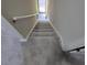 Carpeted staircase with a handrail, leading towards a bright window at 141 Jones Franklin Rd # E, Raleigh, NC 27606