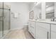 Bright bathroom features double vanity, walk-in shower with glass door, and neutral tile flooring at 1437 Newpoint Dr, Durham, NC 27713