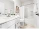Bright bathroom features a single sink vanity, shower-tub combo, and neutral tile flooring at 1437 Newpoint Dr, Durham, NC 27713