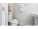 Modern half-bathroom featuring a toilet, sink, and towel rack at 1437 Newpoint Dr, Durham, NC 27713