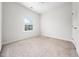 Bright bedroom features neutral carpet, ceiling fan, and a window with a view at 1437 Newpoint Dr, Durham, NC 27713
