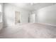 Spacious bedroom with neutral carpet, ceiling fan, and access to an ensuite bathroom at 1437 Newpoint Dr, Durham, NC 27713