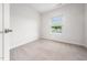 Cozy bedroom features neutral carpet and a window with a view at 1437 Newpoint Dr, Durham, NC 27713