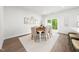 Dining area featuring light-toned walls, modern decor, and a sliding door to the backyard area at 1437 Newpoint Dr, Durham, NC 27713