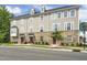 Beautiful three-story townhome showcasing the brick and siding exterior with multiple windows and landscaping at 1437 Newpoint Dr, Durham, NC 27713
