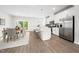 Bright, modern kitchen with white cabinets, stainless steel appliances, an island and adjacent dining area at 1437 Newpoint Dr, Durham, NC 27713