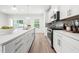 Modern kitchen with stainless steel appliances, white cabinets and countertops, and a large island at 1437 Newpoint Dr, Durham, NC 27713