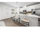 Modern kitchen island with white countertop, seating, stainless appliances, and stylish pendant lighting at 1437 Newpoint Dr, Durham, NC 27713
