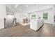 Open concept kitchen and dining area with modern fixtures, island seating, and hardwood floors at 1437 Newpoint Dr, Durham, NC 27713