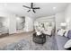 Open floor plan living area with stairs, ceiling fan, and views of the kitchen and dining room at 1437 Newpoint Dr, Durham, NC 27713
