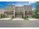 Back view of three-story townhomes with garages and wooden balconies at 1437 Newpoint Dr, Durham, NC 27713