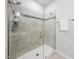 Bright, modern shower stall with gray tile, glass door, and chrome fixtures at 1437 Newpoint Dr, Durham, NC 27713