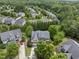 Aerial view of a well-maintained neighborhood with mature trees, landscaped yards, and spacious homes in a suburban setting at 1612 Rainesview Ln, Apex, NC 27502
