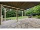 Covered patio with stone flooring and a view of the expansive backyard at 1612 Rainesview Ln, Apex, NC 27502
