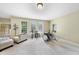 Finished basement with neutral carpet, bright windows, and entertainment or music setup at 1612 Rainesview Ln, Apex, NC 27502