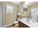 Well-lit bathroom featuring a vanity with sink, toilet, and framed mirror; perfect for daily routines at 1612 Rainesview Ln, Apex, NC 27502