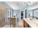 Large bathroom with double sinks, glass shower, and separate tub at 1612 Rainesview Ln, Apex, NC 27502