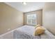 Serene bedroom with a cozy bed, neutral walls, carpet, and a bright window offering natural light at 1612 Rainesview Ln, Apex, NC 27502