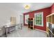 Spacious bedroom with light-colored carpeting, bright red accent wall, and two large windows at 1612 Rainesview Ln, Apex, NC 27502
