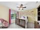 Cheerful bedroom with a whimsical flower wall decal, bright yellow walls, and a ceiling fan at 1612 Rainesview Ln, Apex, NC 27502