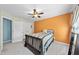 Cozy bedroom with orange accent wall, ceiling fan, and a comfortable-looking bed at 1612 Rainesview Ln, Apex, NC 27502