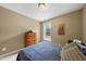 Bedroom with neutral paint, natural light, cozy bed and a wooden dresser at 1612 Rainesview Ln, Apex, NC 27502