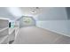 Spacious bonus room featuring large window, vaulted ceilings, and built-in shelving at 1612 Rainesview Ln, Apex, NC 27502