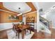 Elegant dining room featuring wood floors, wainscoting, decorative ceiling, and stylish furnishings perfect for entertaining at 1612 Rainesview Ln, Apex, NC 27502