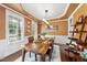Cozy dining area featuring a wooden table set for a meal, shelving unit, and natural light at 1612 Rainesview Ln, Apex, NC 27502