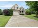 Lovely two-story house featuring stone accents, attached garage, and driveway, nestled in a well-maintained neighborhood at 1612 Rainesview Ln, Apex, NC 27502