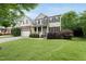 Beautiful two-story home with stone accents, a welcoming front porch, and professionally landscaped front yard at 1612 Rainesview Ln, Apex, NC 27502