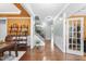 Inviting hallway features wainscoting, hardwood floors, and open access to the dining room and staircase at 1612 Rainesview Ln, Apex, NC 27502