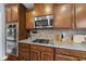 Kitchen with stainless steel oven, microwave and granite countertops at 1612 Rainesview Ln, Apex, NC 27502
