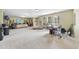 Bright and spacious living room featuring multiple windows and recessed lighting at 1612 Rainesview Ln, Apex, NC 27502