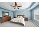 Spacious main bedroom featuring tray ceiling, ceiling fan, and large window for plenty of natural light at 1612 Rainesview Ln, Apex, NC 27502