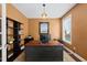 Dedicated home office with a large desk, built-in shelving, and natural light from a large window at 1612 Rainesview Ln, Apex, NC 27502