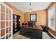 Bright home office with a large desk, shelving, and natural light creating a productive workspace at 1612 Rainesview Ln, Apex, NC 27502