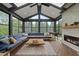 Bright sunroom with fireplace, large windows and view to the back yard at 1612 Rainesview Ln, Apex, NC 27502