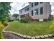 Manicured backyard with lush green lawn and mature landscaping at 1637 Dodford Ct, Wake Forest, NC 27587