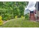 Lush backyard featuring a raised deck area, beautiful lawn, and landscaping at 1637 Dodford Ct, Wake Forest, NC 27587