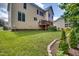 Well-maintained backyard with green lawn and landscaping, featuring a deck and backyard at 1637 Dodford Ct, Wake Forest, NC 27587