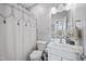 Clean bathroom with a white vanity, white toilet, and a shower-tub combo with white shower curtain at 1637 Dodford Ct, Wake Forest, NC 27587