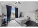 Well-lit bedroom with dark curtains, black desk chair and hardwood flooring at 1637 Dodford Ct, Wake Forest, NC 27587
