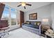 Cozy bedroom with a large window, gray walls, neutral carpet and a daybed at 1637 Dodford Ct, Wake Forest, NC 27587