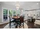 Charming dining area with a round table, chandelier, and view into the modern kitchen at 1637 Dodford Ct, Wake Forest, NC 27587