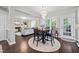Open dining area flowing into the living room, featuring a stylish chandelier and neutral decor at 1637 Dodford Ct, Wake Forest, NC 27587