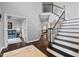 Bright foyer showcasing hardwood floors, an elegant staircase with iron railings, and modern gray wall paint at 1637 Dodford Ct, Wake Forest, NC 27587