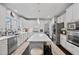 Bright kitchen featuring white cabinets, a center island with seating, and stainless steel appliances at 1637 Dodford Ct, Wake Forest, NC 27587