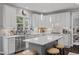 Bright kitchen featuring an island, white cabinets, marble countertops, and pendant lighting at 1637 Dodford Ct, Wake Forest, NC 27587