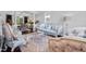 Living room featuring hardwood floors, stylish blue furniture, and lots of natural light at 1637 Dodford Ct, Wake Forest, NC 27587